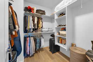 Walk in closet featuring light wood-style flooring
