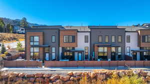 Rear view of property with a fenced backyard, a patio area, and a mountain view