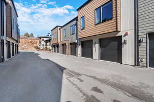 View of asphalt road featuring a residential view