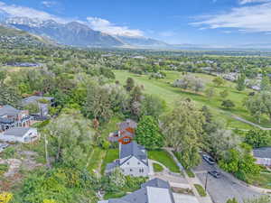 Aerial view of residential area featuring mountains and a local golf course