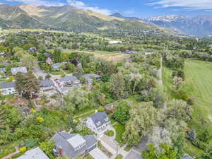 Aerial view of residential area with mountains and a golf course