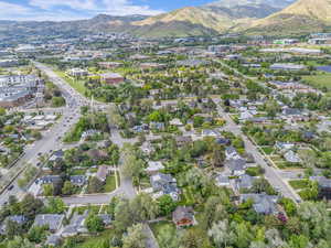 Aerial view of property's location featuring a mountain backdrop and nearby suburban area