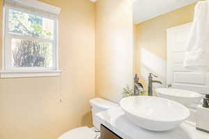 Main Level Bathroom featuring vanity and toilet