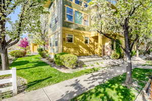 View of front facade with a front lawn and patio
