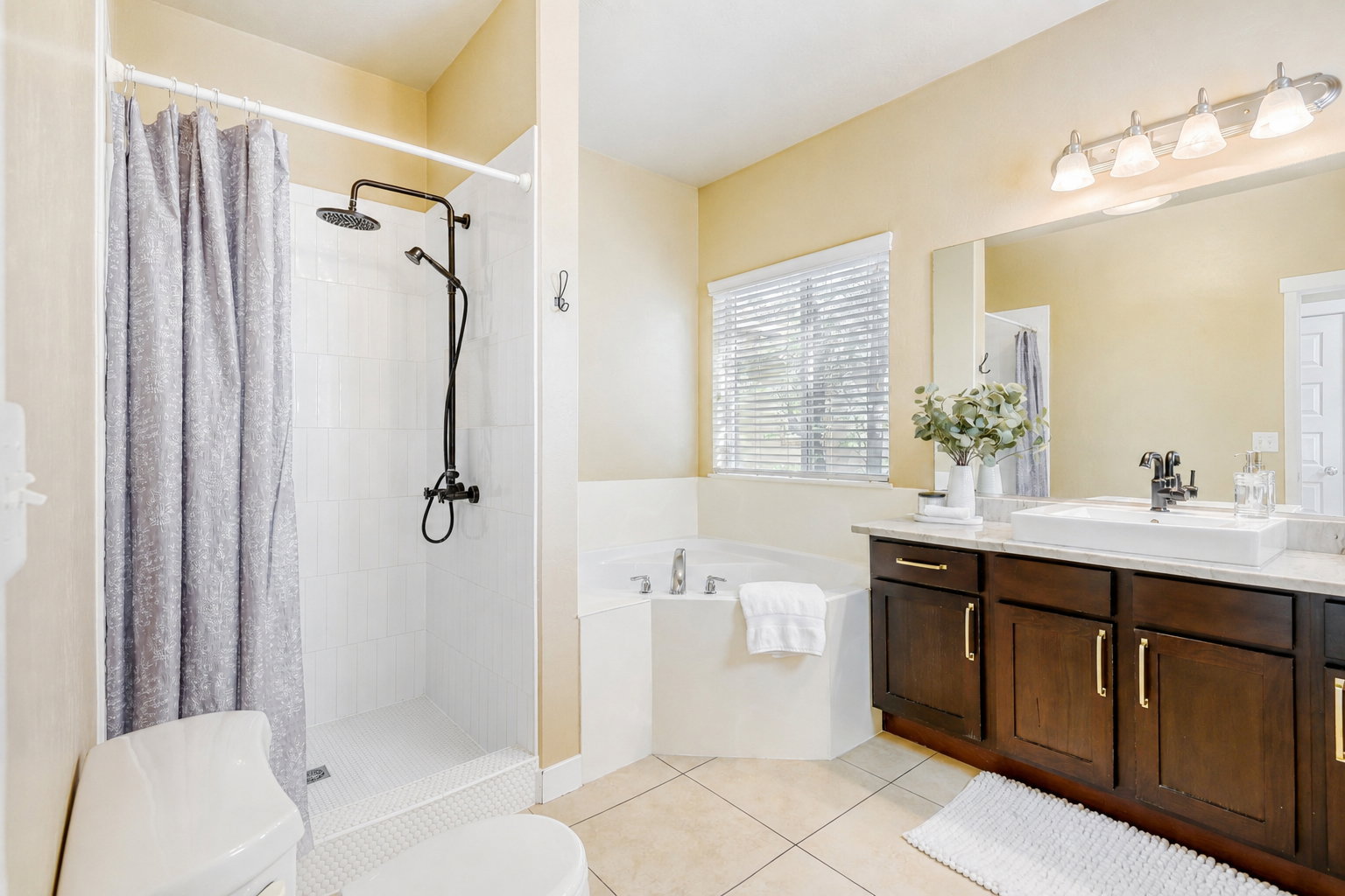 5 piece Primary Bath with vanity, a garden tub, a shower, and light tile floors