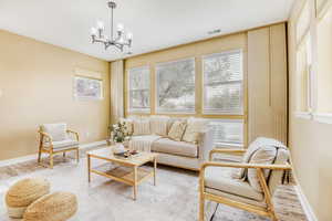 Living room with wood finished floors and a chandelier