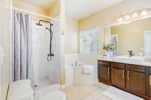 5 piece Primary Bath with vanity, a garden tub, a shower, and light tile floors