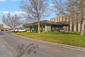 View of front of house featuring a front lawn and stucco siding