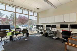 Office with a high ceiling and expansive windows