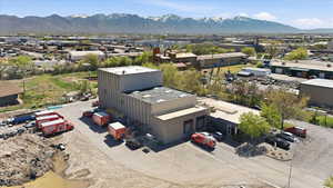 Aerial view of industrial structures and a mountainous background