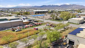 Aerial view of a mountain backdrop and an industrial area