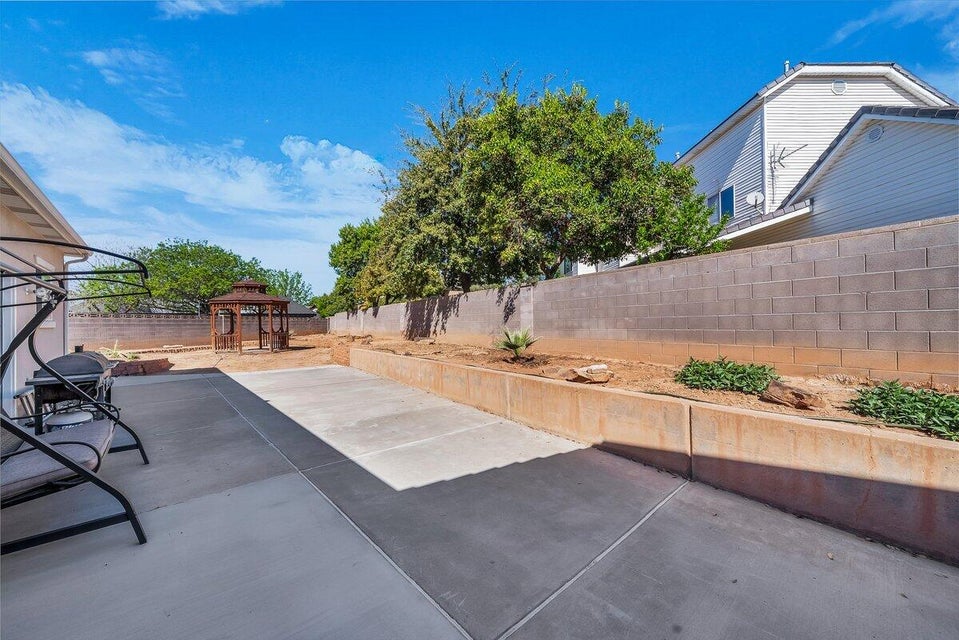 Fenced backyard featuring a gazebo and a patio area