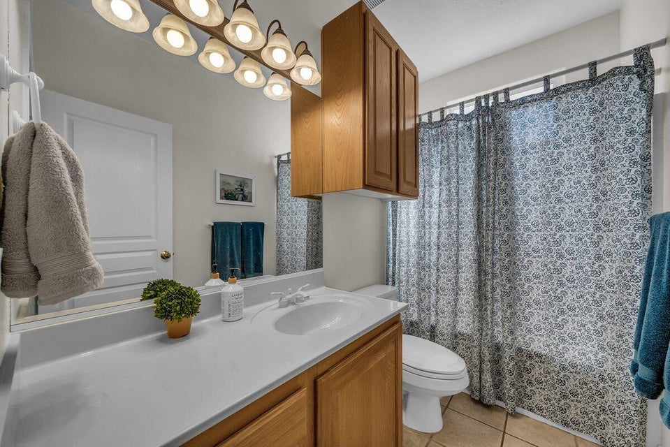Full bathroom with vanity and light tile patterned floors
