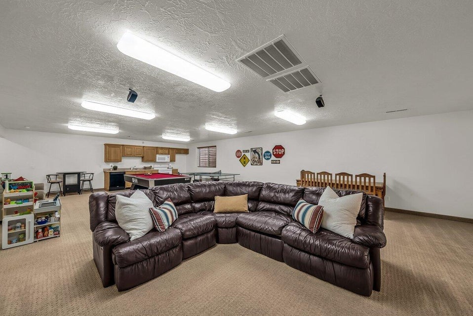 Living room with a textured ceiling and light carpet