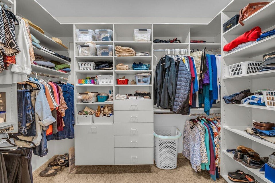 Walk in closet featuring light carpet