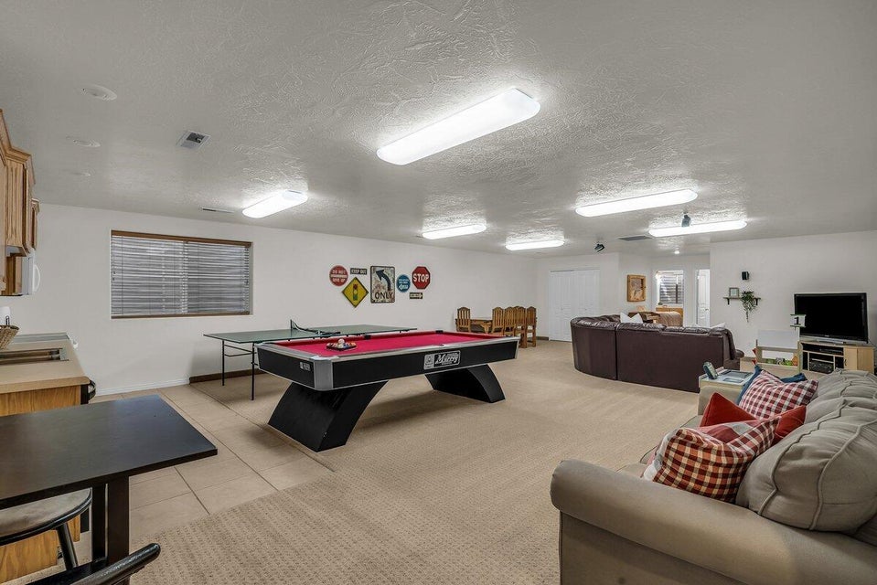 Playroom with a textured ceiling, light tile patterned flooring, and billiards table