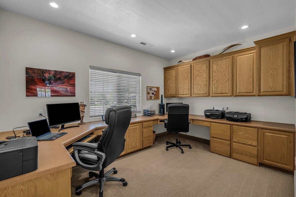 Office space with light colored carpet, built in study area, and recessed lighting