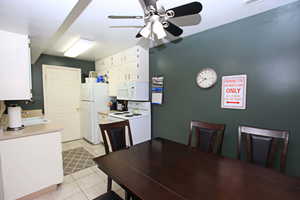 Dining area with ceiling fan and light tile patterned floors