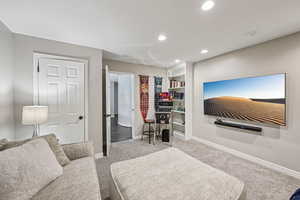 Bedroom with light carpet and recessed lighting