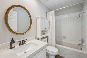 Full bathroom featuring vanity and shower / bath combination with curtain