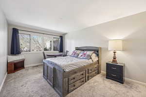 Carpeted bedroom with baseboards