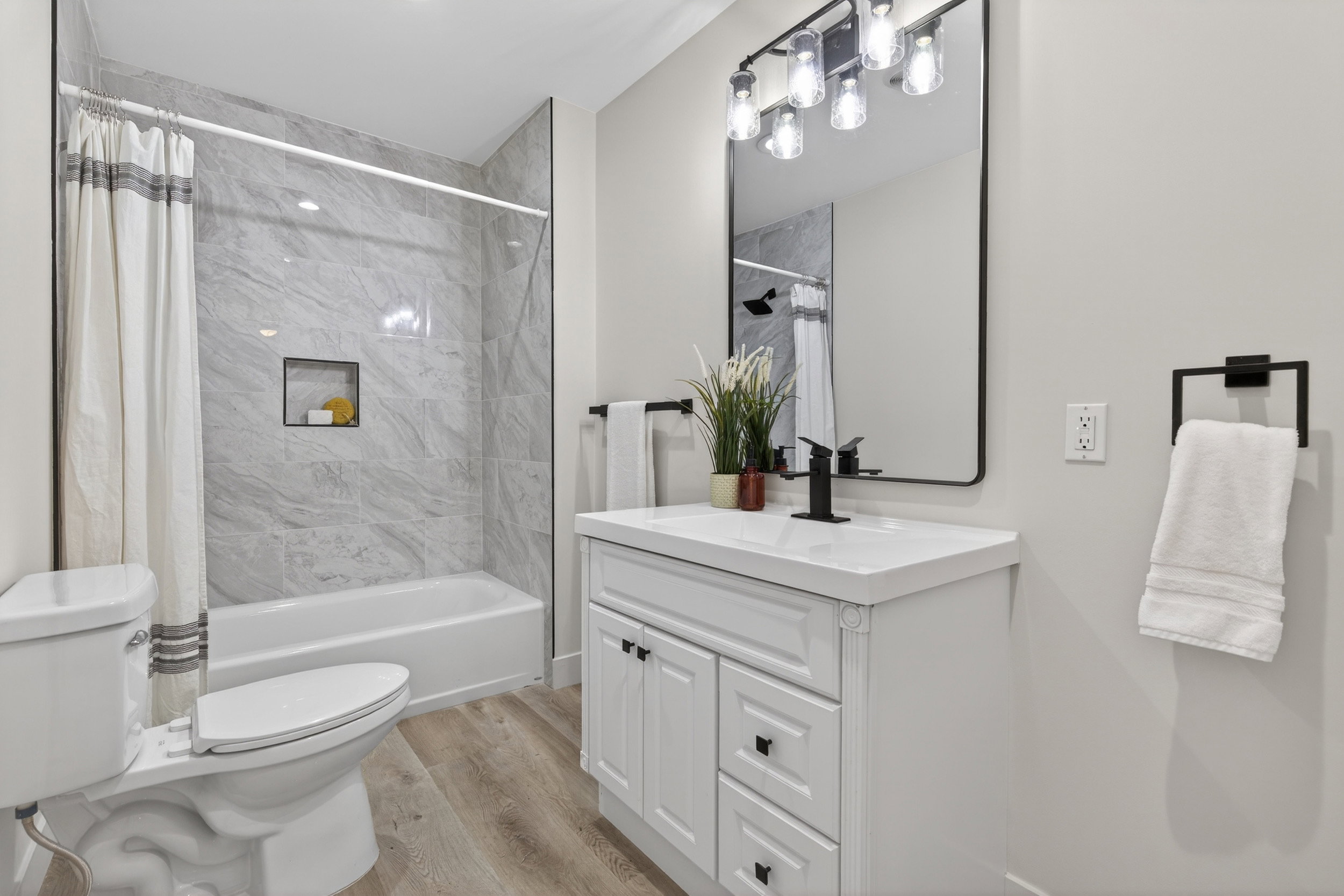 Bathroom featuring vanity, light wood-style floors, and shower / bath combo