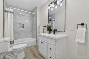Bathroom featuring vanity, light wood-style floors, and shower / bath combo