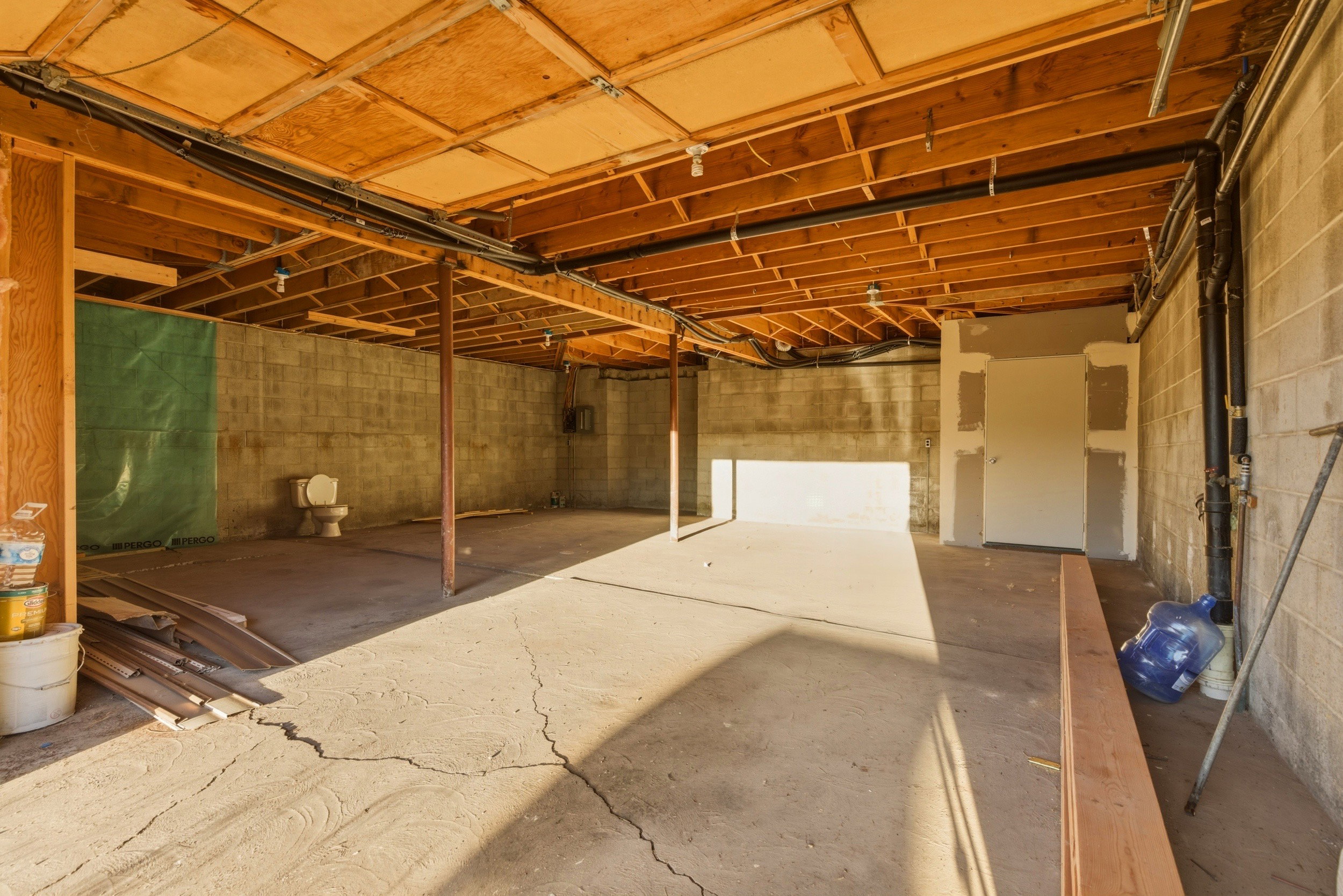 Unfinished basement with concrete block wall