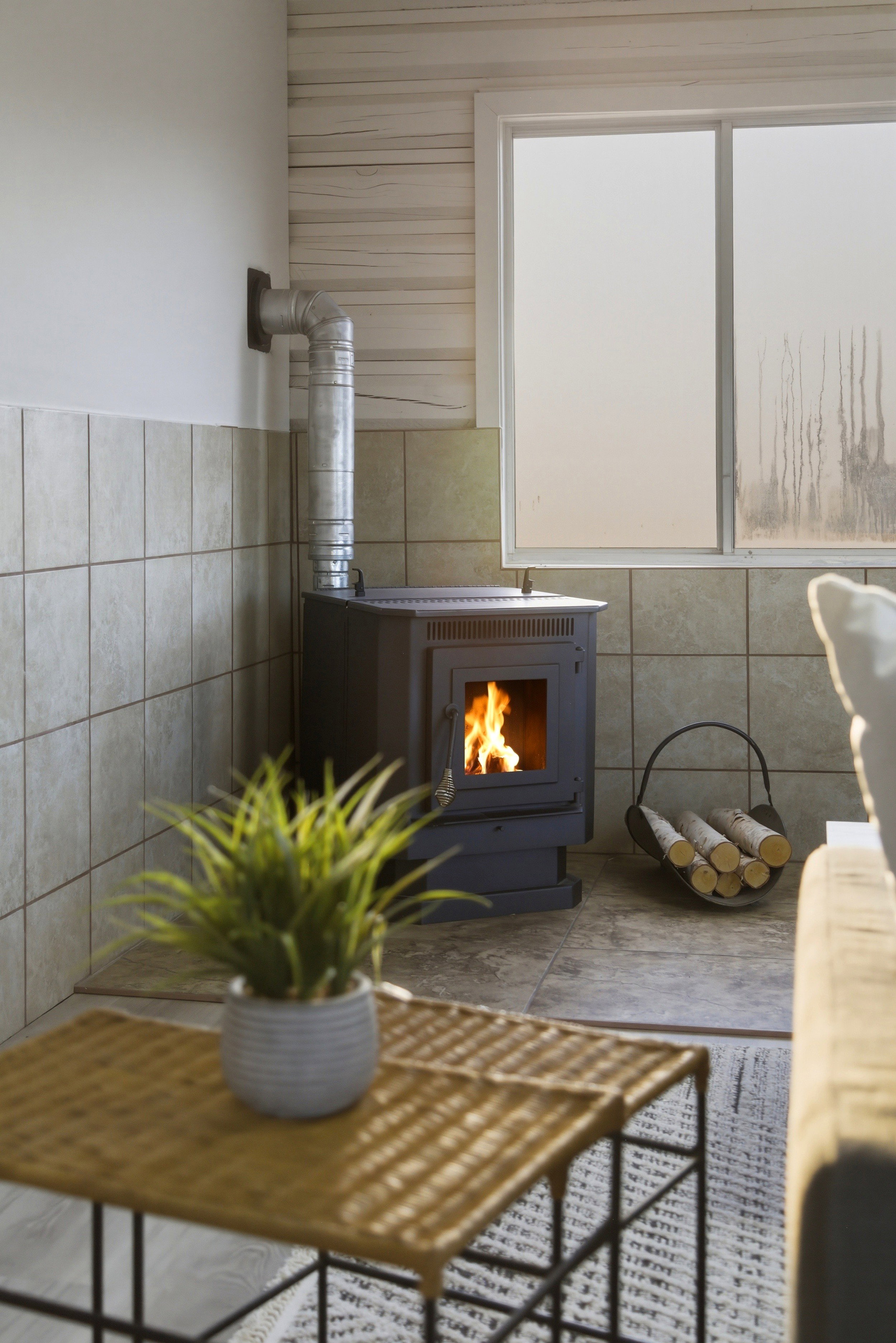 Detailed view of a wood stove and tile walls