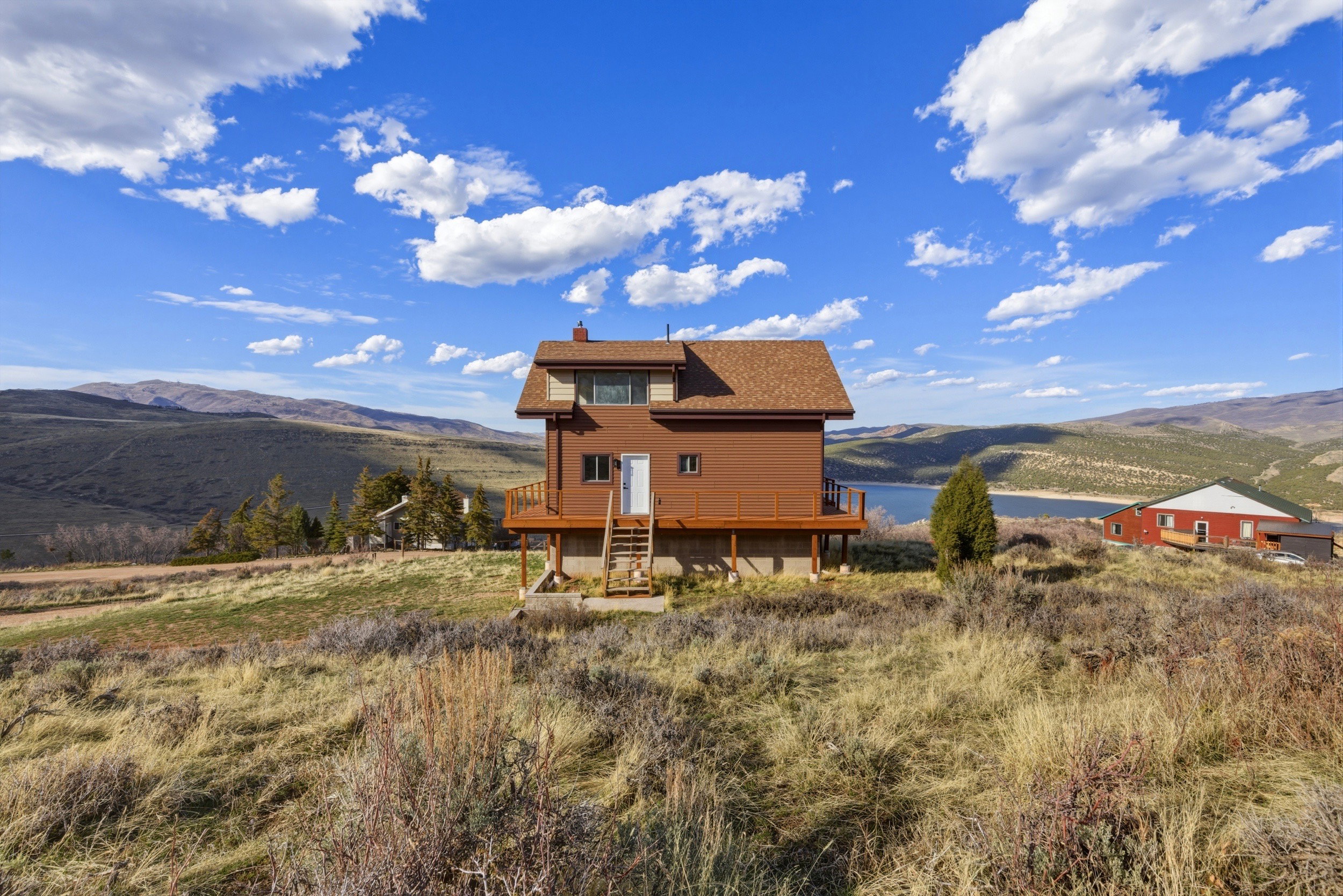 Back of house featuring a deck with mountain view and a chimney
