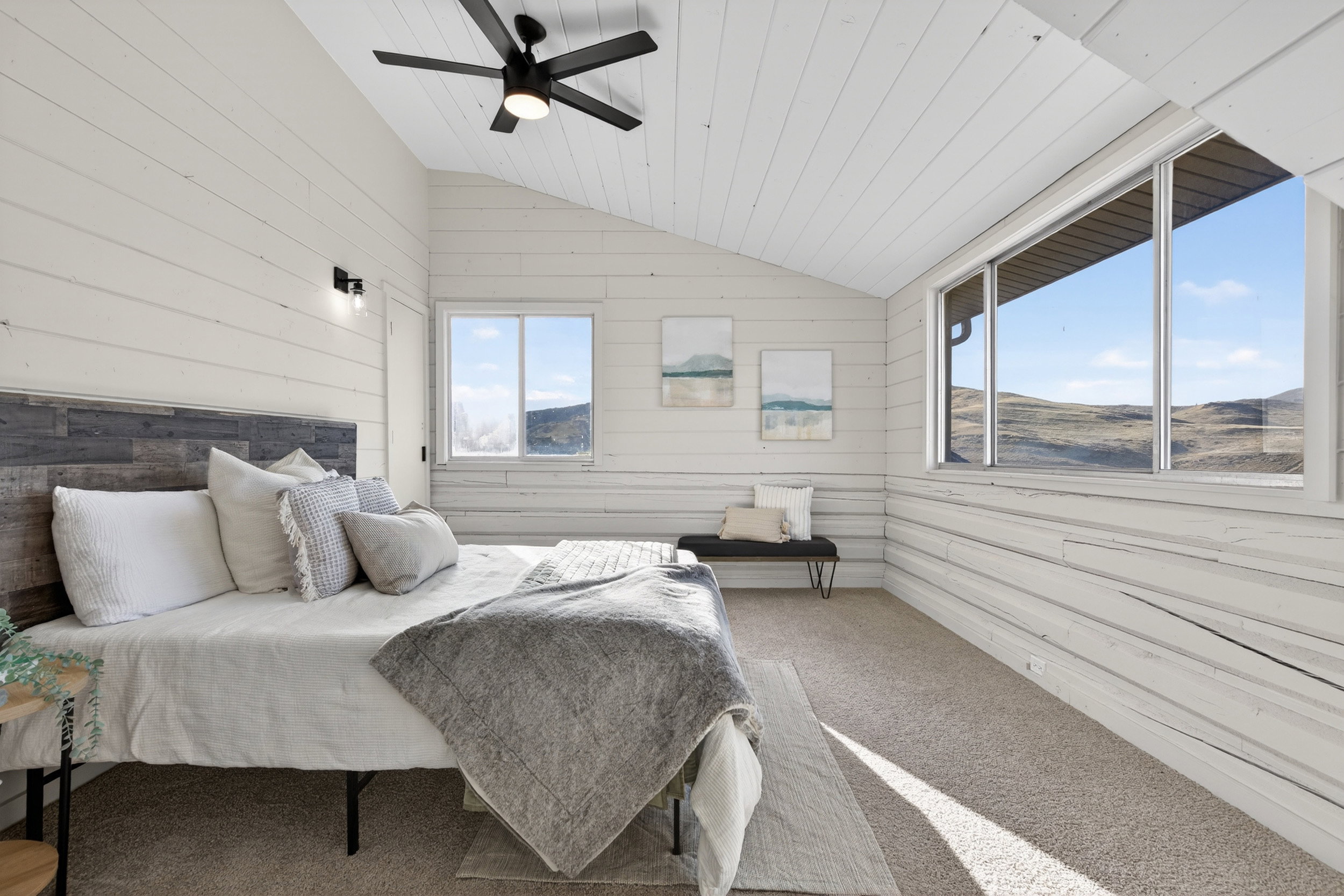 Bedroom featuring wood walls, carpet floors, ceiling fan, and a vaulted wooden ceiling