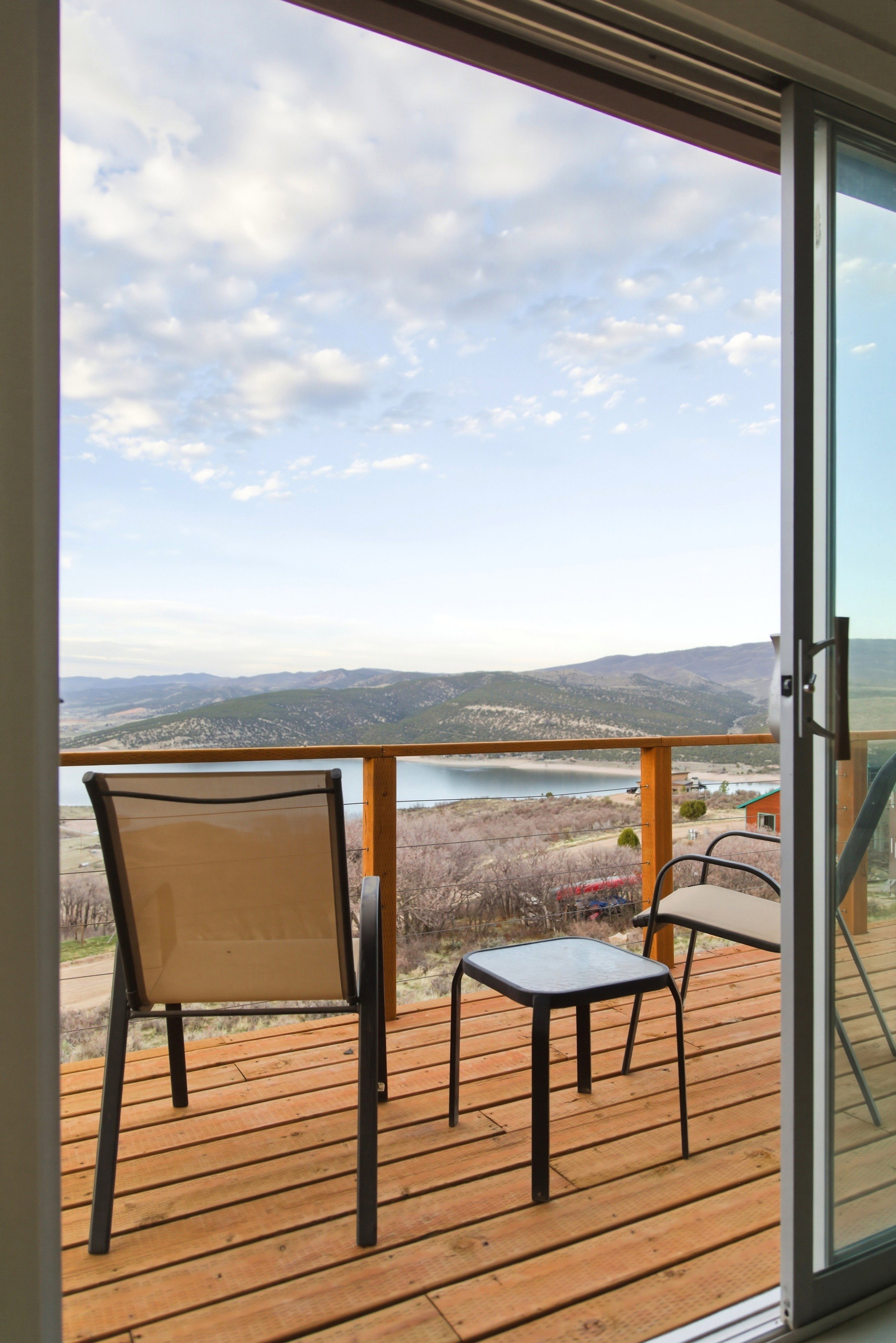 Balcony with a water and mountain view