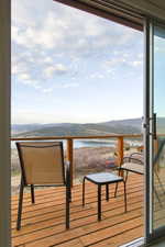 Balcony with a water and mountain view