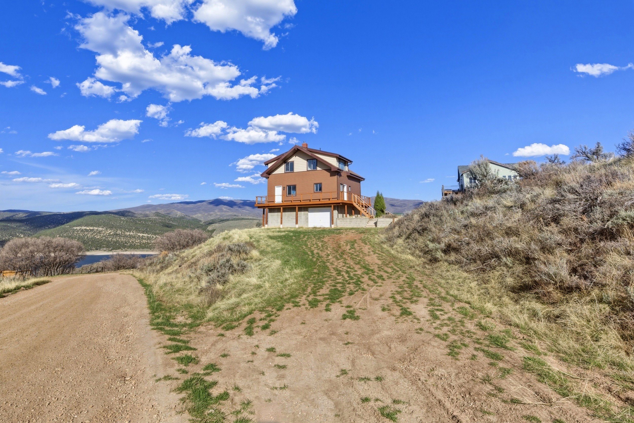 Exterior space featuring a mountain view, a garage, and driveway