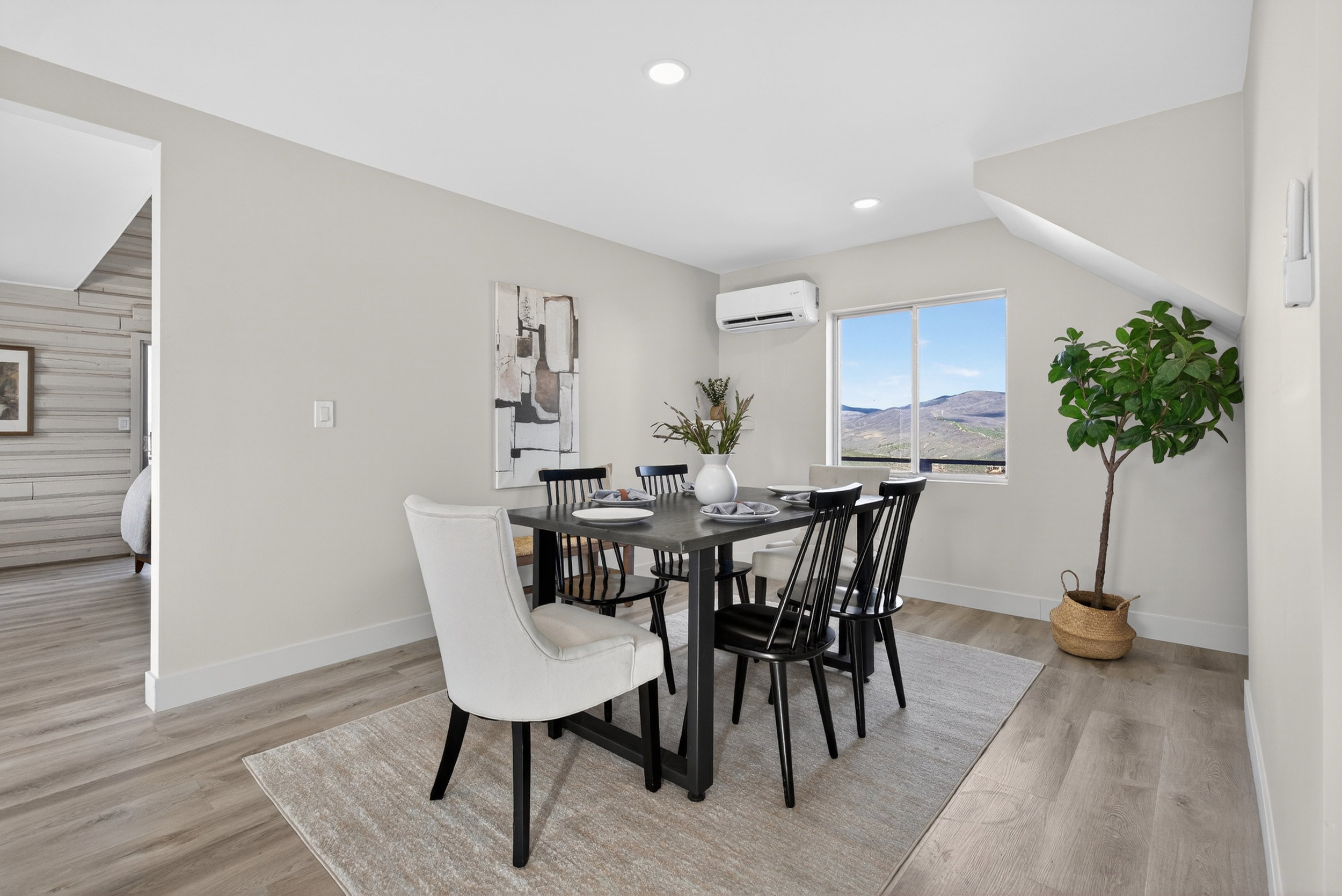 Dining room with a mountain view, light wood-style flooring, and recessed lighting
