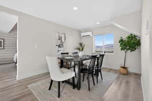 Dining room with a mountain view, light wood-style flooring, and recessed lighting