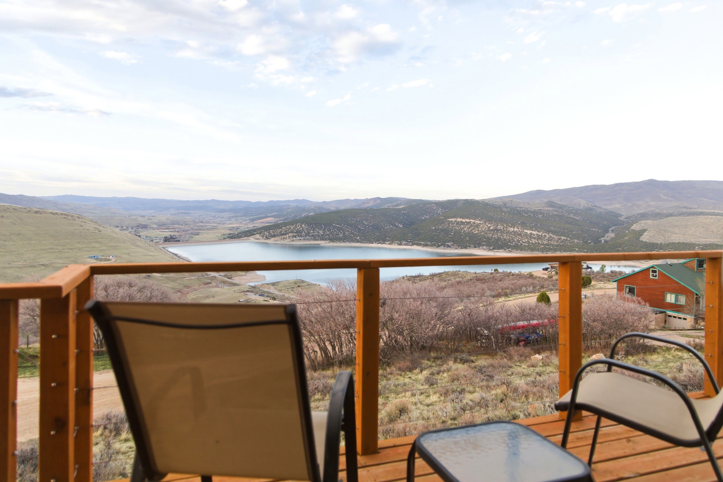 Wooden terrace featuring a water and mountain view