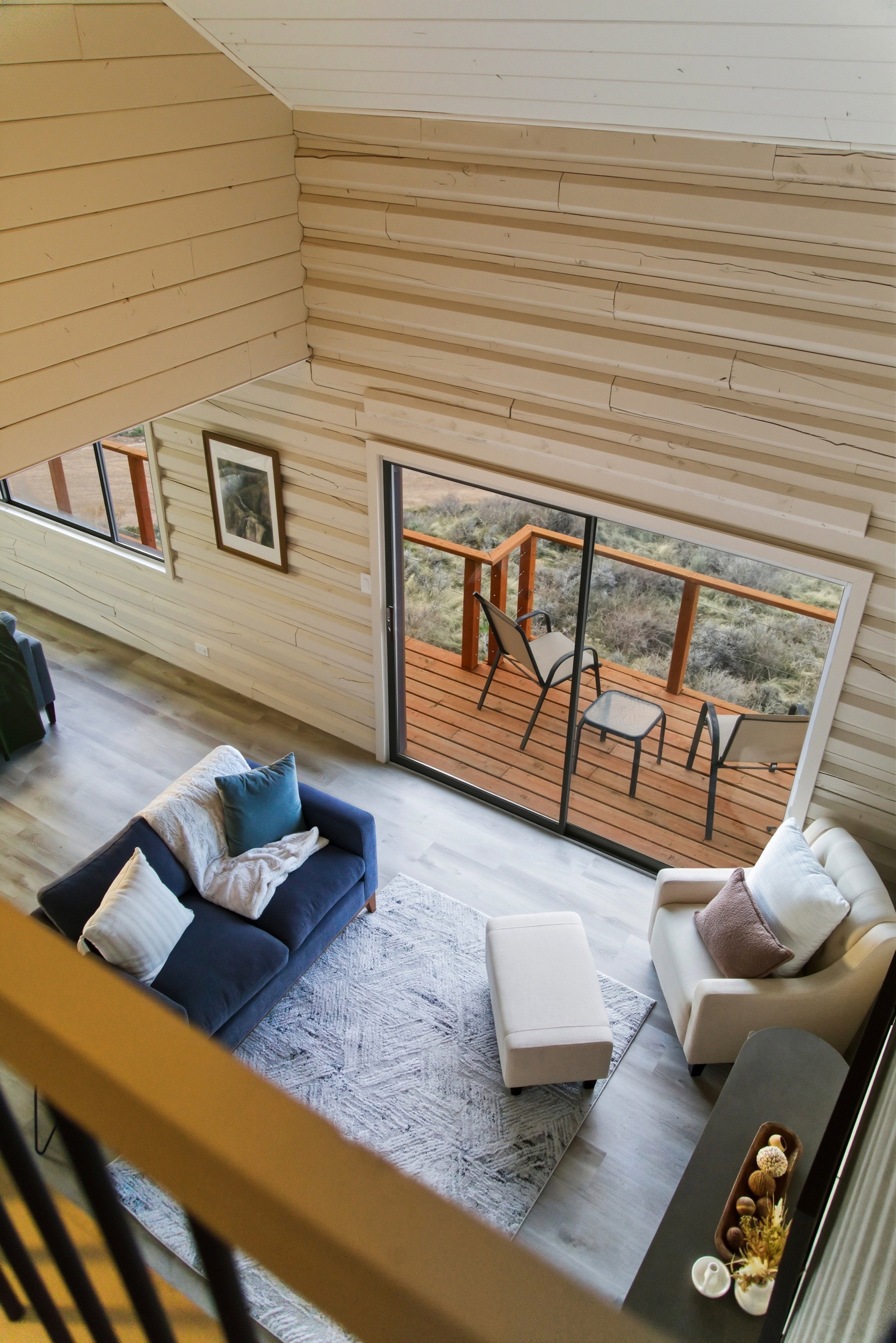 Living area with wood finished floors and wooden walls