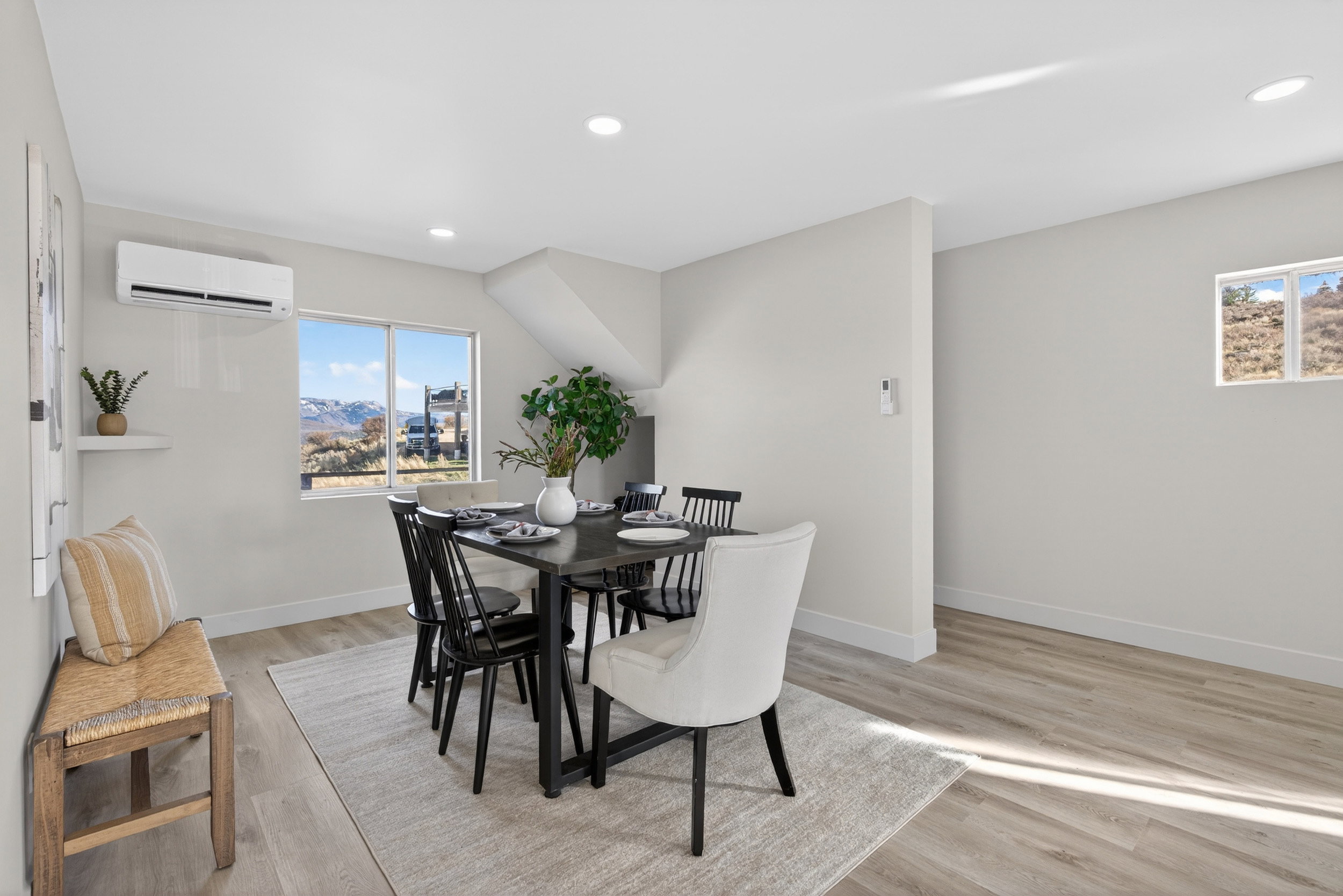 Dining area featuring light wood-style floors, plenty of natural light, and recessed lighting