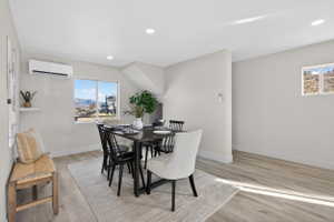 Dining area featuring light wood-style floors, plenty of natural light, and recessed lighting