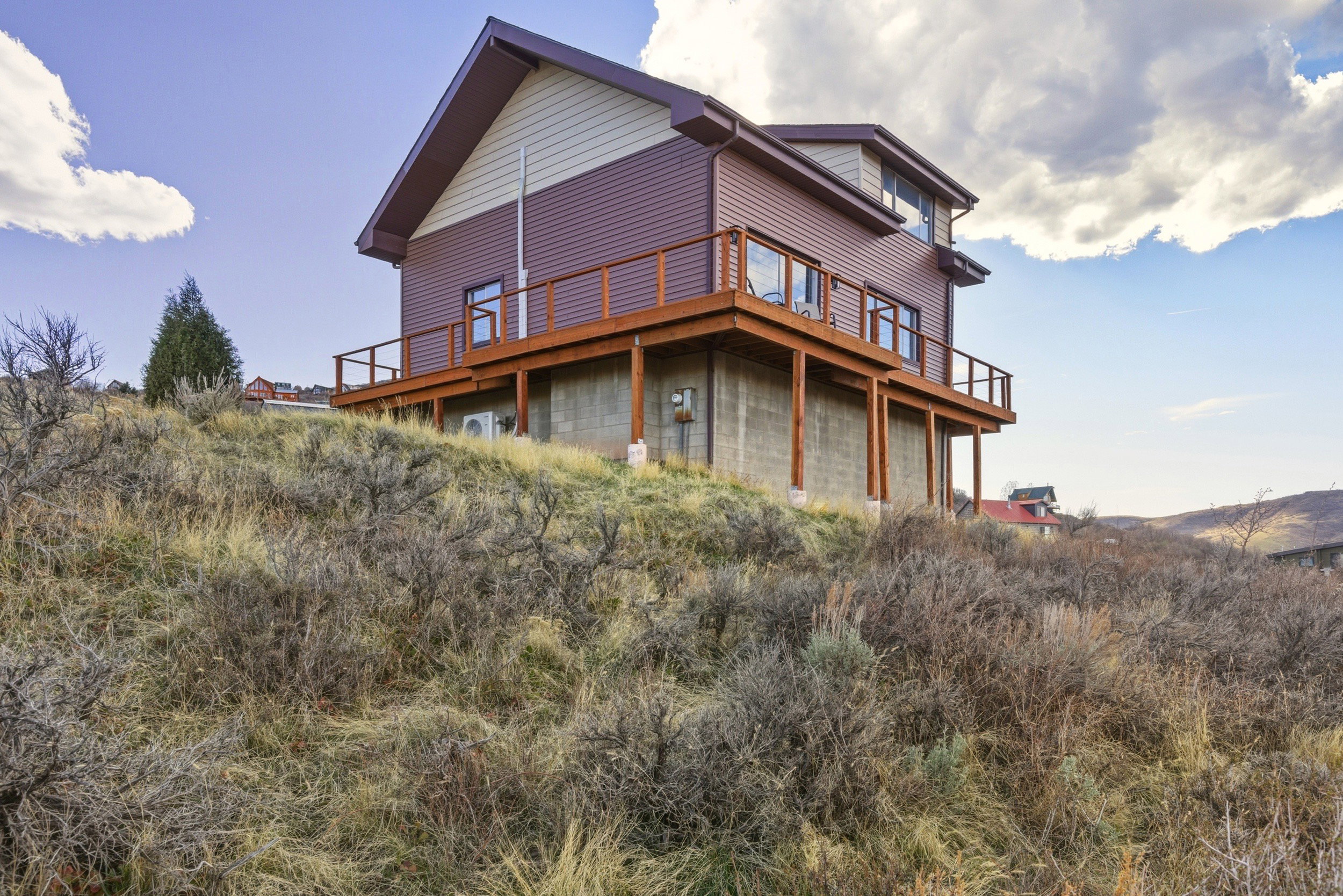 Back of house featuring a wooden deck