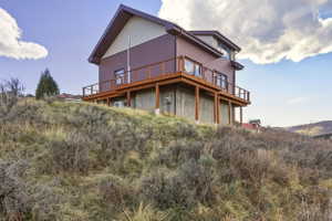 Back of house featuring a wooden deck