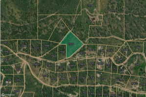 Aerial map of property and surrounding area featuring property parcel outlined
