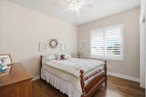 Bedroom featuring dark wood-style floors and a ceiling fan