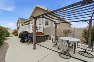 View of patio with outdoor dining space and a pergola