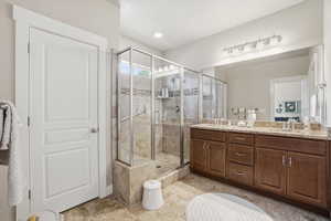 Primary full bath featuring double vanity, shower, and linen closet