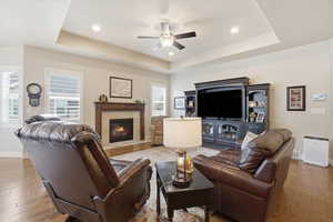 Great room has tray ceiling and recessed lighting