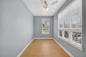 Optional bedroom / office featuring a ceiling fan and light wood-style flooring