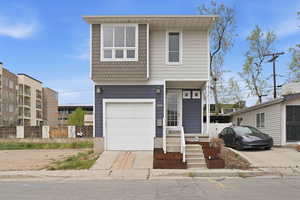 View of front facade with a garage and concrete driveway