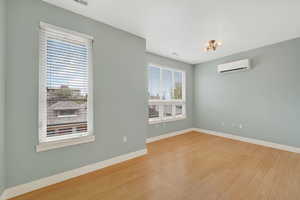 Bedroom with baseboards and light wood finished floors